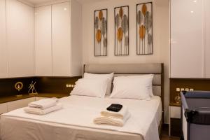 a bedroom with a bed with towels on it at The Monolith in Kalabaka