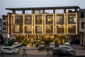 a large building with cars parked in front of it at Hotel The Prithvi Near Delhi Airport in New Delhi