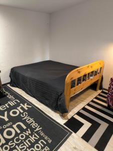 a bedroom with a wooden bed in a room at me contacter avant réservation chambre ecologique indépendante toilette seche in Livry-sur-Seine