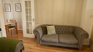 a living room with a couch and a table at Sleeps 5, ideal for contractors in Liverpool +54 photos