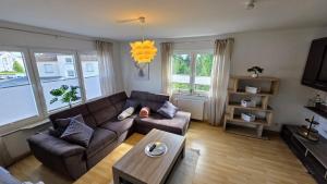 a living room with a couch and a table at Perfect Living in Petersberg