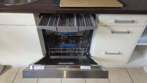 a dishwasher in a kitchen with a dish rack at Perfect Living in Petersberg