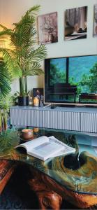 a desk with an open book and a plant on it at La Casa Verde in Seoul