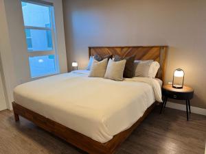a bedroom with a large bed with a large window at Modern Retreat 10 Min from Disneyland With Pool & Gym in Tustin +63 photos