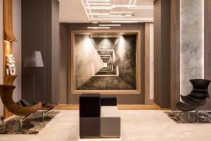 a living room with a painting of a staircase at AC Hotel by Marriott Wroclaw in Wrocław