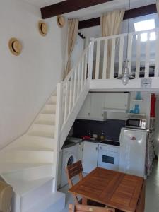 a kitchen with a staircase and a washing machine at Maisonnette - M04231 in Soulac-sur-Mer +6 photos