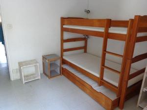 a room with two bunk beds and a table at Maisonnette - M04231 in Soulac-sur-Mer