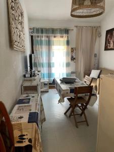 a living room with a table and chairs and a room at Maisonnette - M04231 in Soulac-sur-Mer