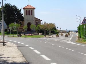 an empty street with a church on the side of a road at Maisonnette - M04231 in Soulac-sur-Mer