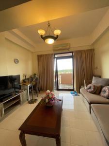 a living room with a couch and a table at Riverbank suites 1008 in Kuching