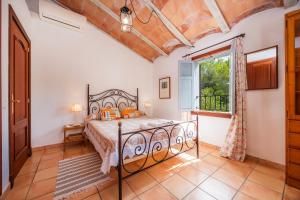 a bedroom with a bed and a window at Finca Es Galliner in Es Carritxo +24 photos