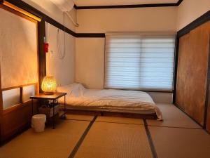 a small bedroom with a bed and a window at Private Suncheon House in Suncheon