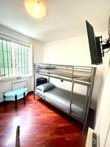 a room with two bunk beds and a television at Cuore della Città- Manerbio in Manerbio