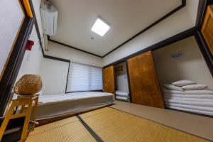 a small room with a bed and a mirror at Private Suncheon House in Suncheon +99 photos