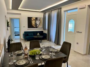 a dining room with a table and chairs and a couch at Casa Loma 2 RHODES-FAMILY VILLA,PRIVATE POOL & FARM in Rhodes Town