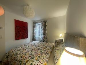 a small bedroom with a bed and a window at Thann centre, 2 BR, terrasse exposée sud, vue sur la Collégiale in Thann