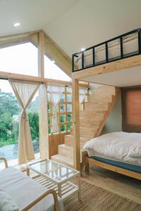 a bedroom with two bunk beds and a staircase at Silver Oak Valley บ่อเกลือสะปัน น่าน in Ban Kham