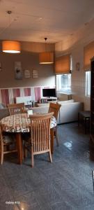 a living room with a table and chairs and a couch at Wenceslas cobergher II appartement 1 in Boutersem