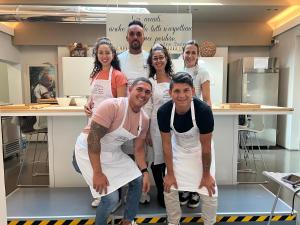 a group of people in a kitchen posing for a picture at Albergo Al Cacciatore Tortellinando in Valeggio sul Mincio