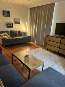 a living room with a couch and a coffee table at Apartment Tzankov in Vidin +4 photos