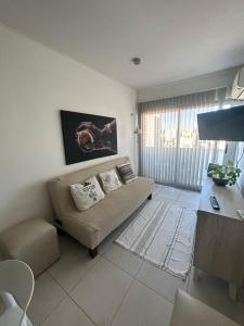 a living room with a couch and a table at La Plata Bs As , departamento vista panoramica a metros de todo in La Plata