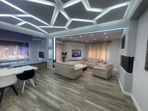 a large living room with couches and a table at Luxury Suite Korca in Korçë