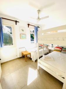 a bedroom with two bunk beds and a window at Can Botana 8 in Cala de Sant Vicenc +16 photos