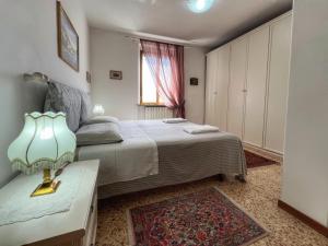 a bedroom with a bed and a table with a lamp at Attico Altucci in Arezzo