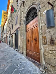 a large wooden door on the side of a building at Attico Altucci in Arezzo