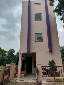 a tall building with purple trim on it at Dstay in in Visakhapatnam