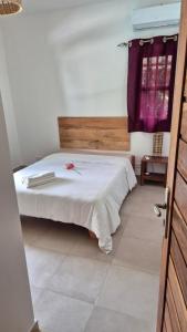 a bedroom with a bed in a room with a window at la maison de la fontaine in Cap Skirring