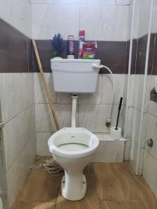 a bathroom with a toilet with a shelf on the wall at Blissful Suite, Studio BNB at Kamakis, Ruiru- in Ruiru +8 photos
