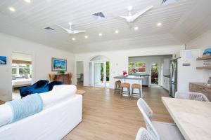 a living room with a white couch and a table at Wish House - Private Beach House Double Bay Beach home in Savannah Sound