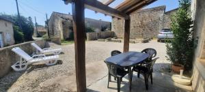a patio with a table and chairs on a patio at Chambre CHARDON - Maison partagée - 2 personnes in Saint-Sauvant
