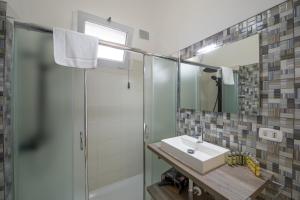 a bathroom with a sink and a shower at Casa Punta Paradiso - Hot Tub and Panoramic Garden in Praiano +22 photos