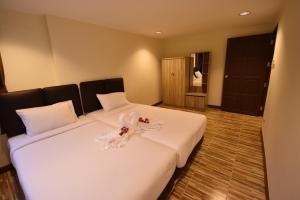 a hotel room with a bed with a bunny on it at Panorama Golf And Country Club in Ban Mai Samrong