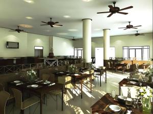 a restaurant with tables and chairs and ceiling fans at Panorama Golf And Country Club in Ban Mai Samrong