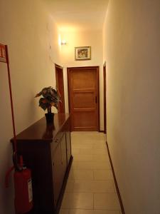 a hallway with a door and a potted plant at Giulia House in Certaldo