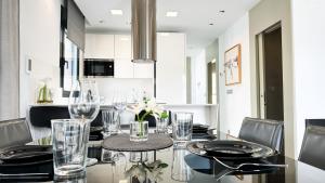 a dining room with a glass table and chairs at BEACH FRONT house LA MATA in La Mata +25 photos