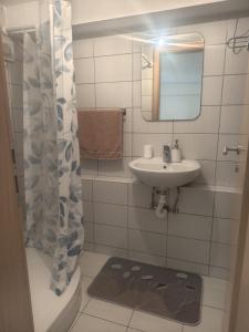 a bathroom with a sink and a toilet and a mirror at Soba Angelina Međugorje in Međugorje
