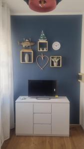 a room with a blue wall with a white desk at L'Ulivo in Povegliano Veronese