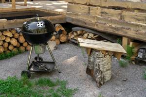 a grill with a pan with a skull on it at Design Cabin with Jacuzzi, Sauna & Nature in Pertunmaa