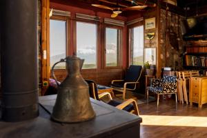 a tea kettle on a table in a room with windows at Kleio in Elatochori
