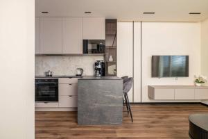 a kitchen with white cabinets and a counter top at Air Conditioned Studio with Mountain View, Parking and Balcony by Noclegi Renters in Tychy +12 photos