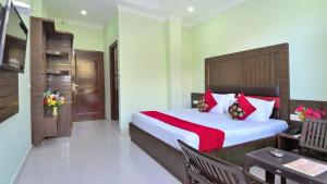 a bedroom with a large bed and a table at Hotel Eco-Nest - Best Stay near Bhagsu Waterfall in McLeod Ganj