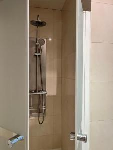a bathroom with a shower with a glass door at Hostal Al-Andalus in Conil de la Frontera +63 photos