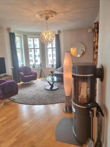 a living room with a fire place in the middle at Central, lovely apartment with a unique view in Bergen +126 photos