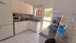 a kitchen with a bottle of water on the counter at Private House in Paphos in Khlorakas
