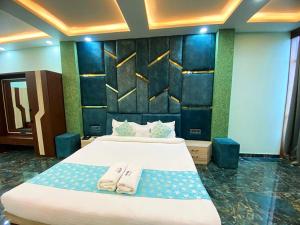a bedroom with a large bed with two towels on it at The Vrinda Haritage Siwan in Siwān