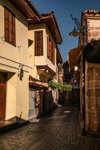 an empty street in an old town with buildings at Bright Yellow Flat Near Beach Old Town Free Wifi in Antalya
